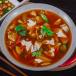 Szechuan Soup with original chicken momos (2 pcs).
