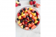 A Bowl Of Cut Fruits With Orange Juice